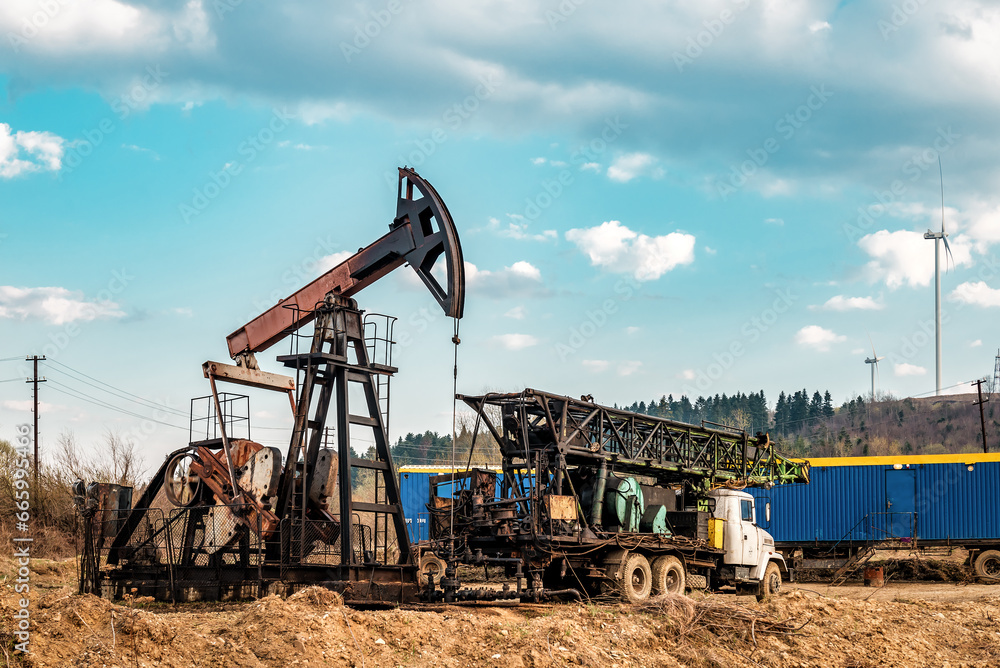 Obraz premium Drilling rig and oil pump at petroleum site. Industrial theme