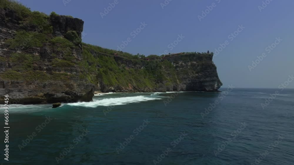 Cliff aerial top down view of a rocky coastline in Uluwatu, Bali. Cliff aerial top down view of a rocky coastline in Uluwatu, Bali.