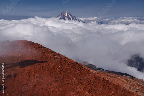 Kamchatka volcanic landscape: view to top of cone of Koryaksky Volcano from scenery active crater of Avacha Volcano on sunny day and blue sky. Russian Far East photo