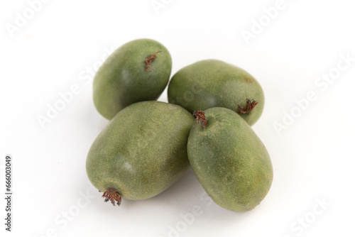 mini kiwi baby fruit, actinidia arguta on white background.