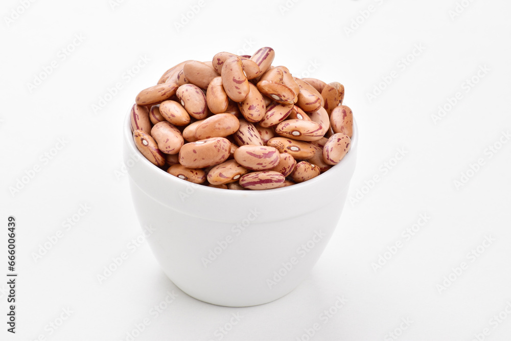Raw kidney beans in bowl on white background Raw kidney beans in bowl on white background