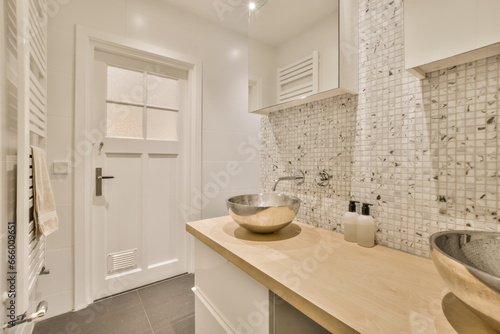 a bathroom with two sinks on the counter and one sink in front of the mirror that has been used for storage