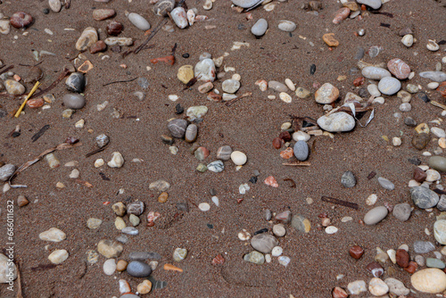 Abstract background beach sand with pebble rocks on the ground at Paralia Ixia beach off Rhodes city