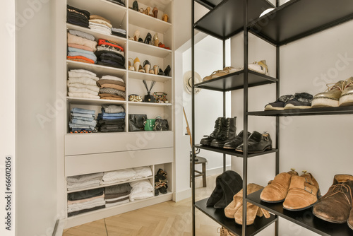 the inside of a walk - in closet with shoes and other items on shelves, as well as they do