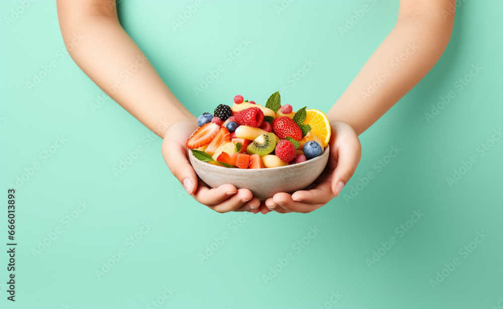 Children's hands hold a bowl of healthy food on a pastel background Children's hands hold a bowl of healthy food on a pastel background