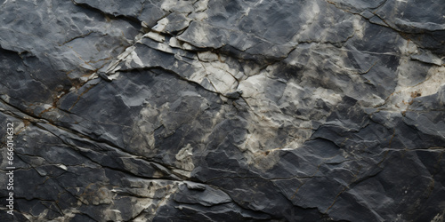 Gray rock formation texture background filled with cracks and crevices.
