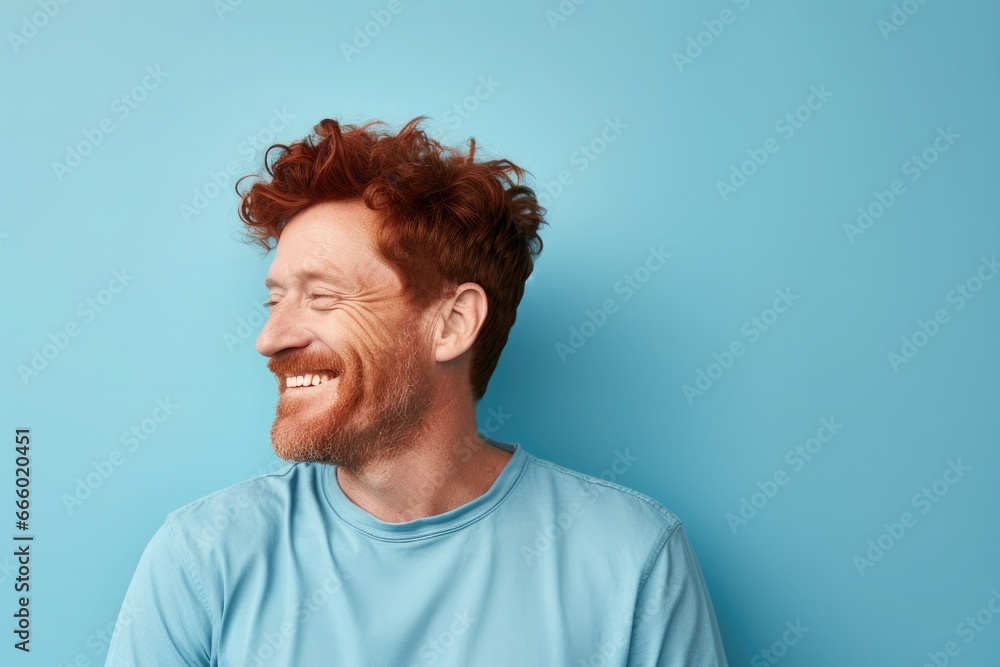 Middle-aged Irish man on blue background looks to the side, cheerful and pleasant. Middle-aged Irish man on blue background looks to the side, cheerful and pleasant.