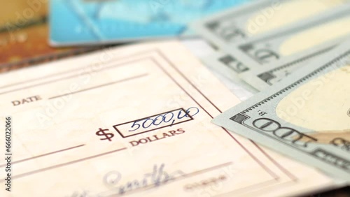 Check Financial Payment, bank credit cards, cash money and bitcoin on table, Paycheck Or Payroll Check