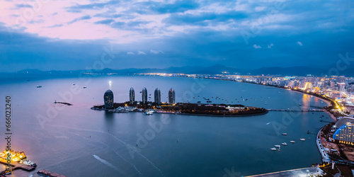 Night View of Phoenix Island and Urban Skyline in Sanya Bay, Hainan, China photo