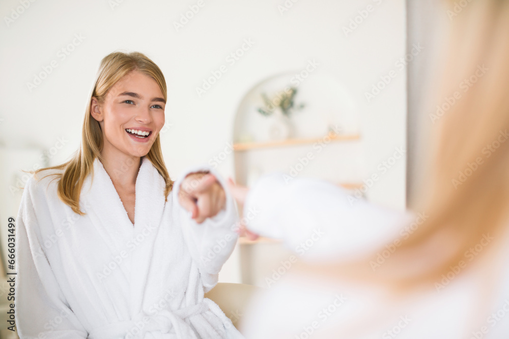 Happy Blonde Woman Pointing Finger At Reflection At Bathroom Happy Blonde Woman Pointing Finger At Reflection At Bathroom