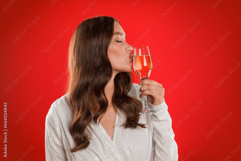 Elegant Lady Kissing Glass Of Sparkling Wine Over Red Background Elegant Lady Kissing Glass Of Sparkling Wine Over Red Background
