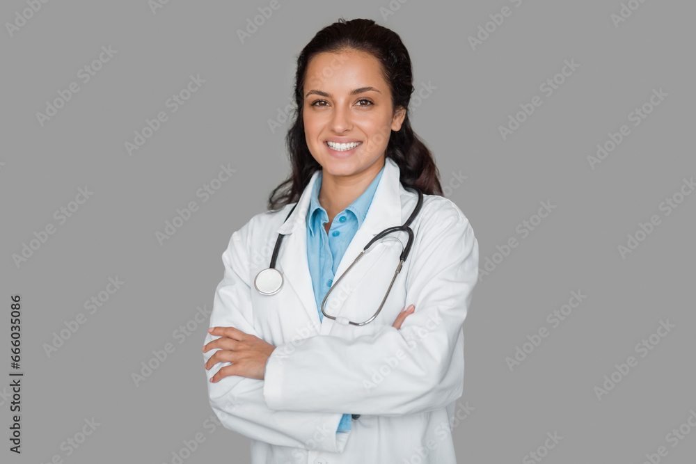 Smiling female doctor with stethoscope, arms crossed Smiling female doctor with stethoscope, arms crossed