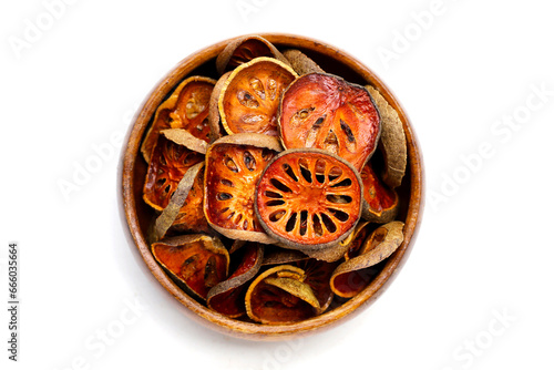 Dried bael fruit slices on white background. photo