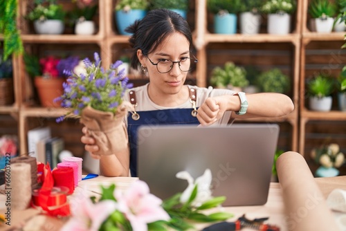 Wallpaper Mural Young hispanic woman working at florist shop doing video call looking unhappy and angry showing rejection and negative with thumbs down gesture. bad expression. Torontodigital.ca