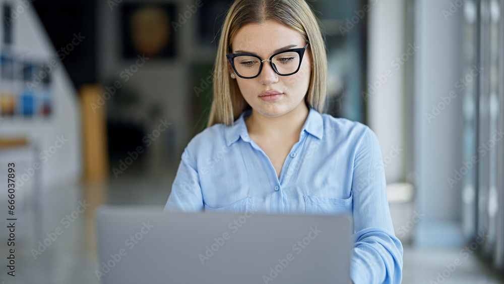 Fototapeta premium Young blonde woman business worker using laptop working at office
