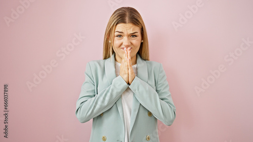 Young blonde woman business worker doing please gesture with hands over isolated pink background photo