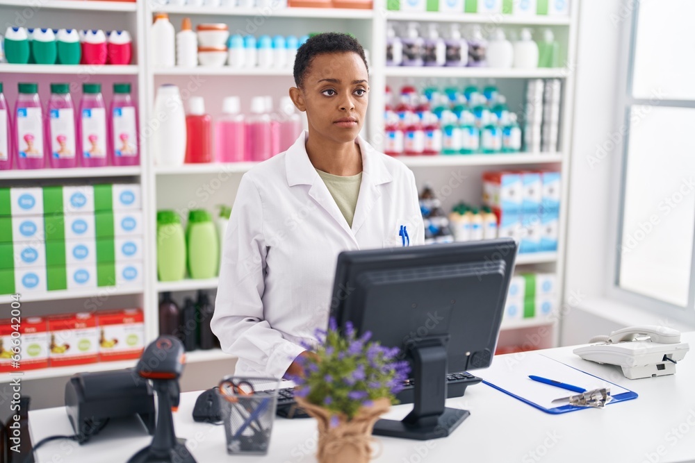 African american woman pharmacist using computer at pharmacy