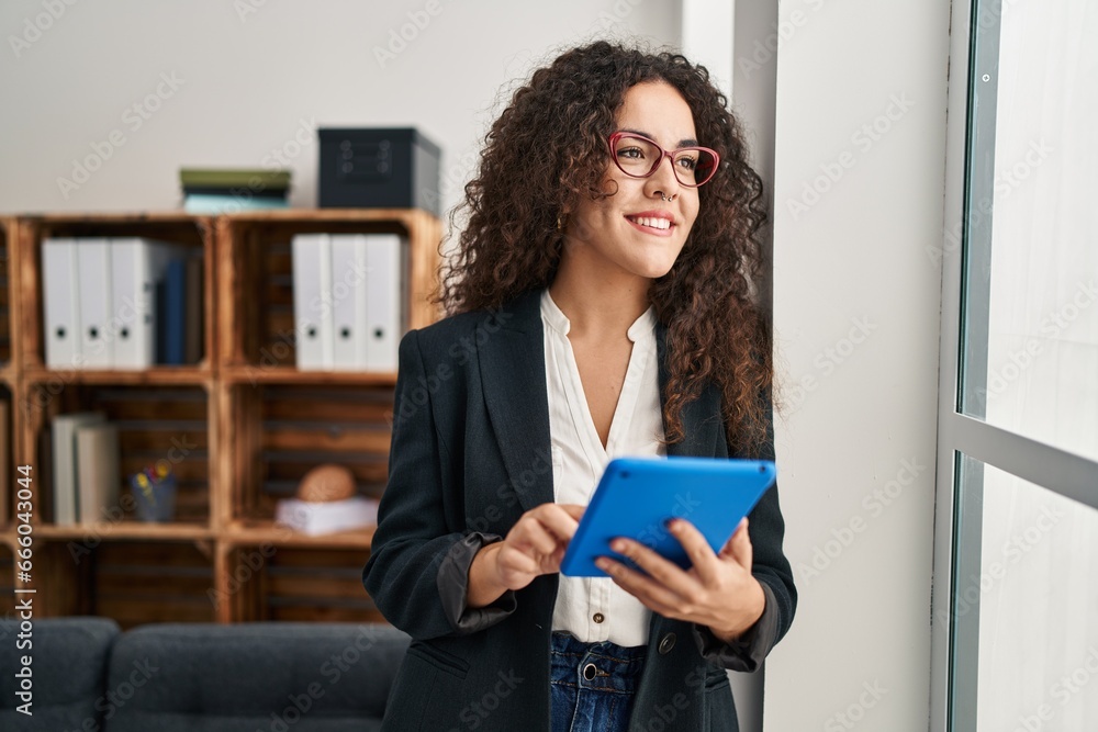 Young beautiful hispanic woman business worker smiling confident using touchpad at office Young beautiful hispanic woman business worker smiling confident using touchpad at office