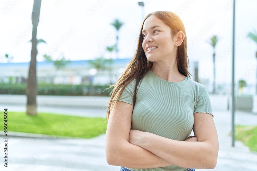 Young beautiful woman standing with arms crossed gesture at street Young beautiful woman standing with arms crossed gesture at street