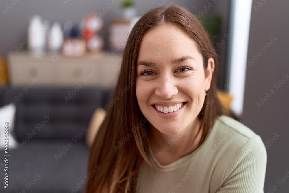Young beautiful woman smiling confident sitting on sofa at home Young beautiful woman smiling confident sitting on sofa at home