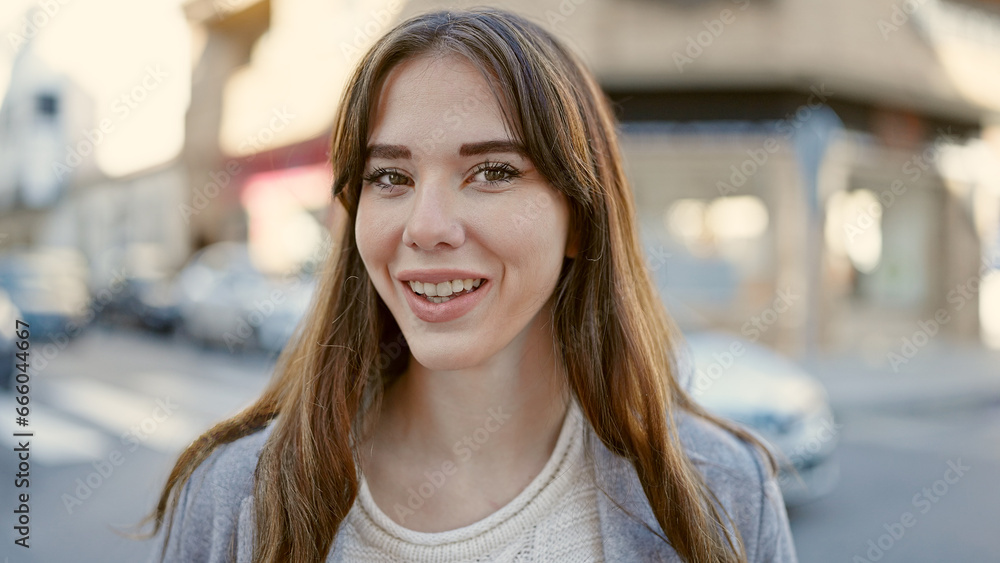 Young hispanic woman smiling confident at street