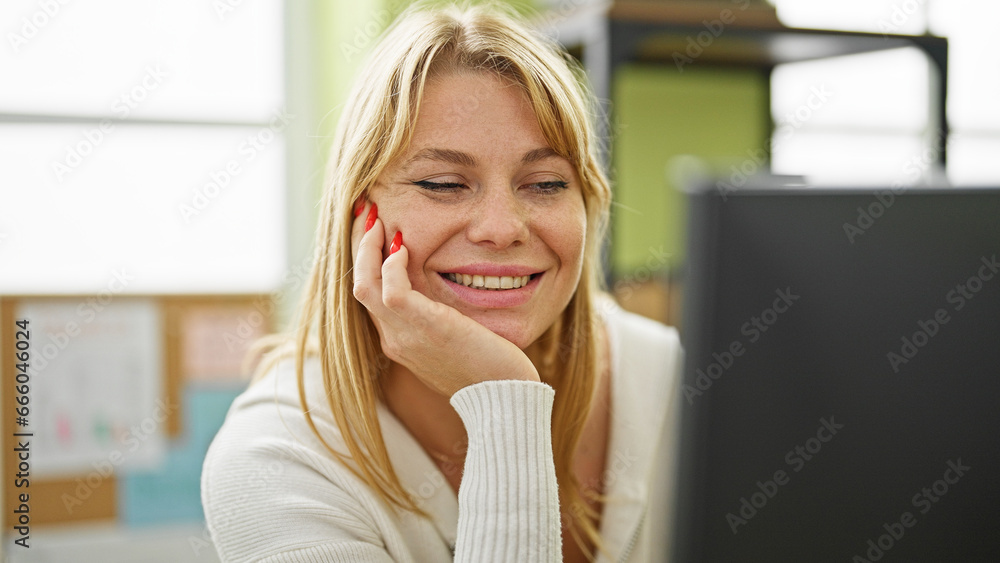 Young blonde woman business worker using computer working at office Young blonde woman business worker using computer working at office