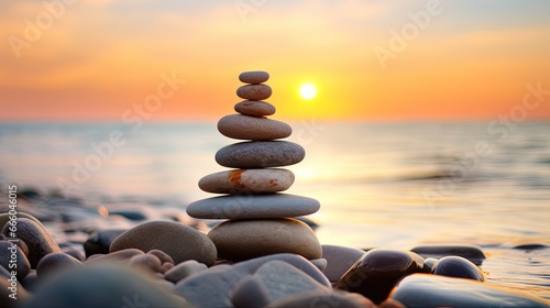 Balanced pebble pyramid silhouette on the beach on sunset. Selective focus Abstract bokeh with Sea on the background. Zen stones on the sea beach  meditation  spa  harmony  calmness  balance concept.