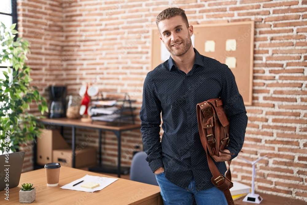 Young caucasian man business worker smiling confident holding briefcase at office Young caucasian man business worker smiling confident holding briefcase at office