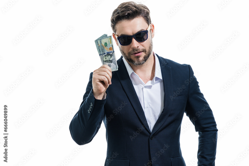 Man in suit holding cash money in dollar banknotes on isolated white background. Studio portrait of businessman with dollar banknotes. Dollar money. Career wealth business. Cash dollar concept. Man in suit holding cash money in dollar banknotes on isolated white background. Studio portrait of businessman with dollar banknotes. Dollar money. Career wealth business. Cash dollar concept.