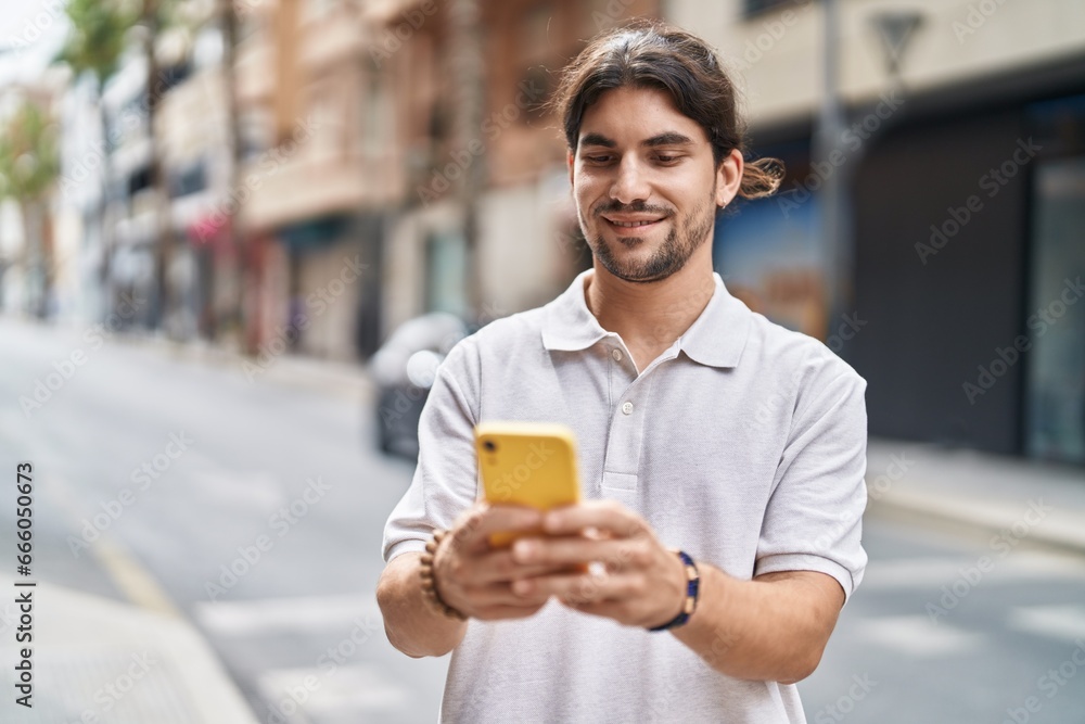 Young hispanic man smiling confident using smartphone at street Young hispanic man smiling confident using smartphone at street