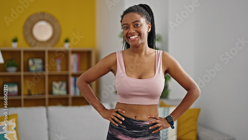 Tableau sur toile African american woman wearing sportswear smiling at home