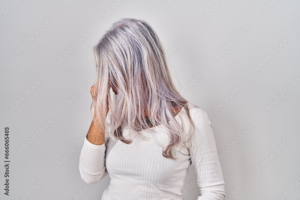 Φωτογραφία Middle age woman with grey hair standing over white background tired rubbing nose and eyes feeling fatigue and headache