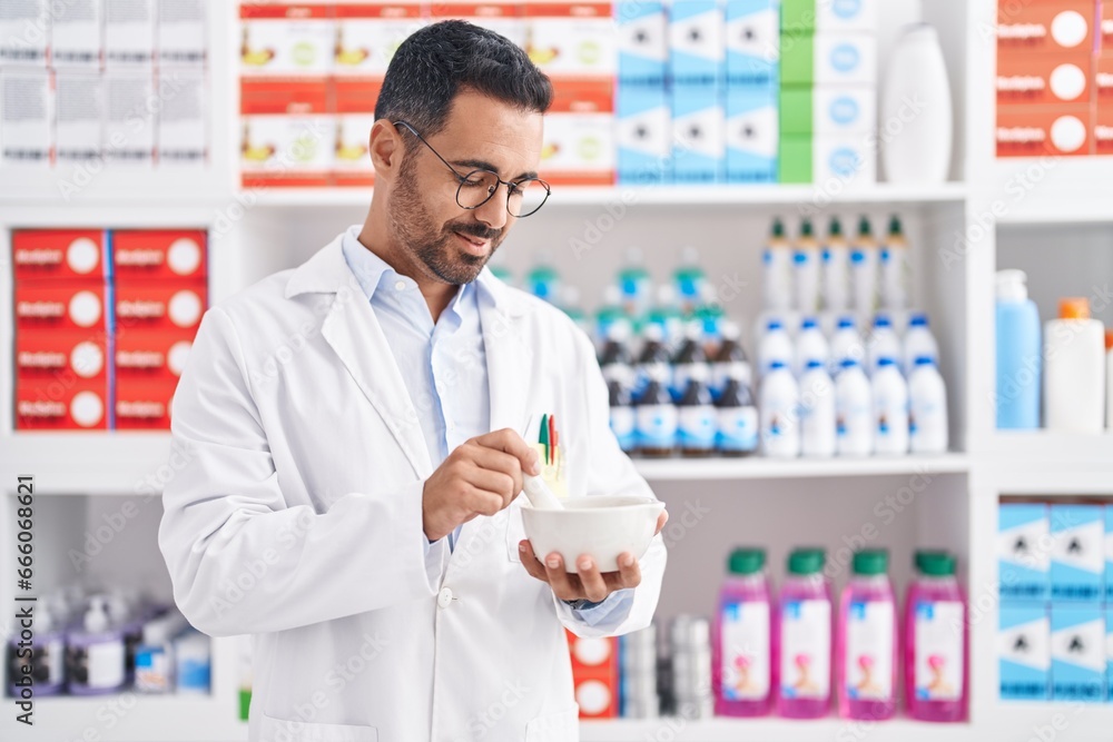 Young hispanic man pharmacist smiling confident working at pharmacy Young hispanic man pharmacist smiling confident working at pharmacy