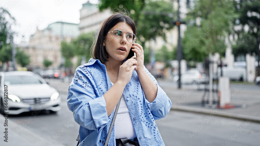 Young beautiful hispanic woman smiling happy speaking on the phone in the streets of Vienna Young beautiful hispanic woman smiling happy speaking on the phone in the streets of Vienna