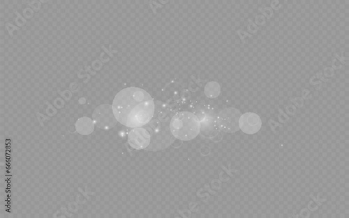 Dust sparks and stars shine with a special light. Christmas light effect. Glittering particles of magic dust.Vector sparkles on a transparent background.