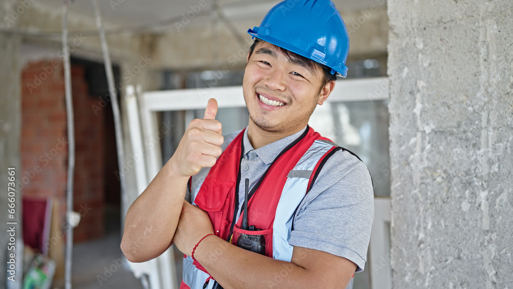 builder smiling confident doing thumb up gesture at construction site builder smiling confident doing thumb up gesture at construction site