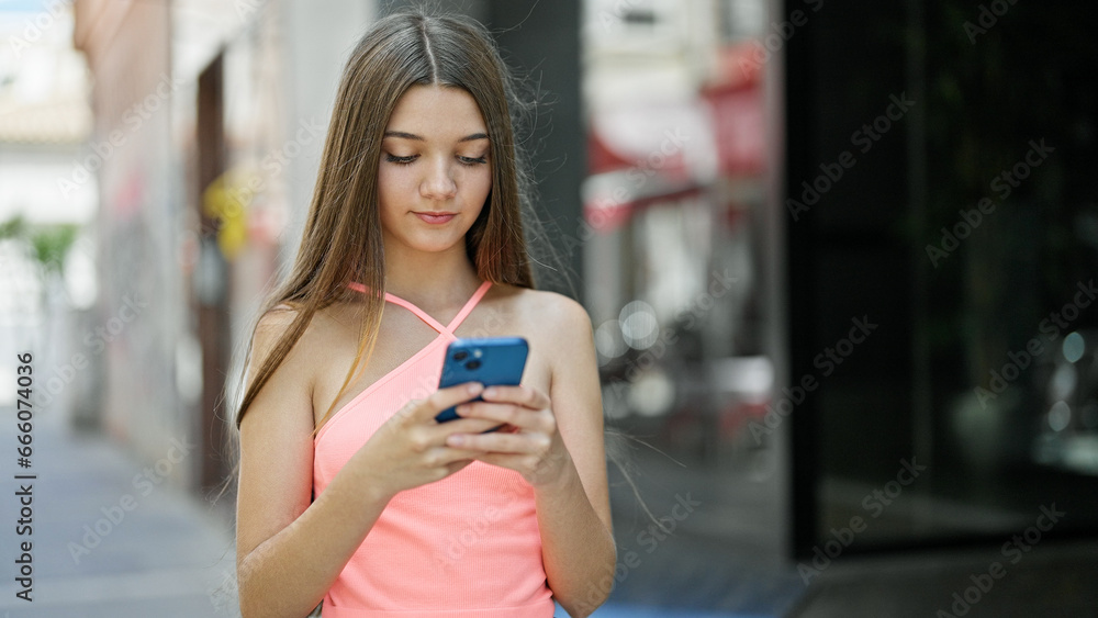 Young beautiful girl using smartphone with serious face at street Young beautiful girl using smartphone with serious face at street