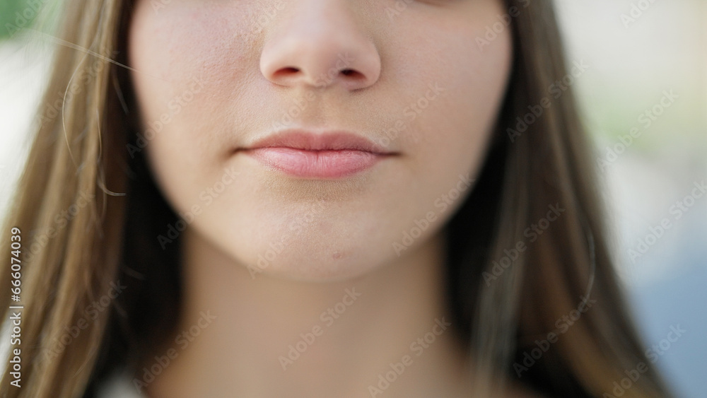 Young beautiful girl standing with serious expression at street Young beautiful girl standing with serious expression at street