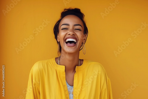 happy Moroccan woman with typical moroccan tunic standing against yellow wall