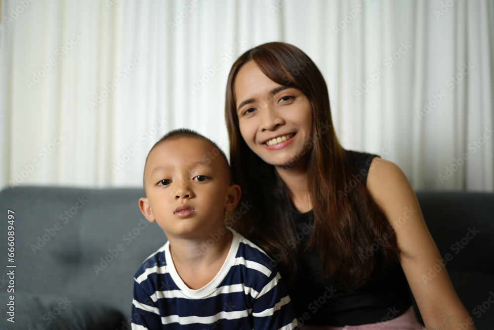 Mother and son smiling happily inside the house Mother and son smiling happily inside the house