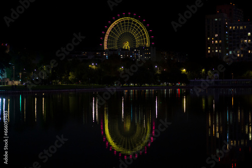 THE SUN OF MOSCOW. Ferris Wheel in Moscow. View from Ostankino pond.Night.