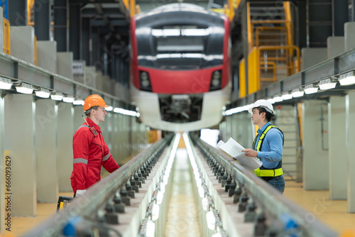 After the electric train is parked in the electric train repair shop, Electric train engineer and technician with tools inspect the railway and electric trains in accordance with the inspection round