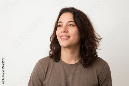 Everyday people. A smiling man with long hair. Wearing a brown shirt. On a white background. Friendly man. Clean shaven. Baby face. Portrait.