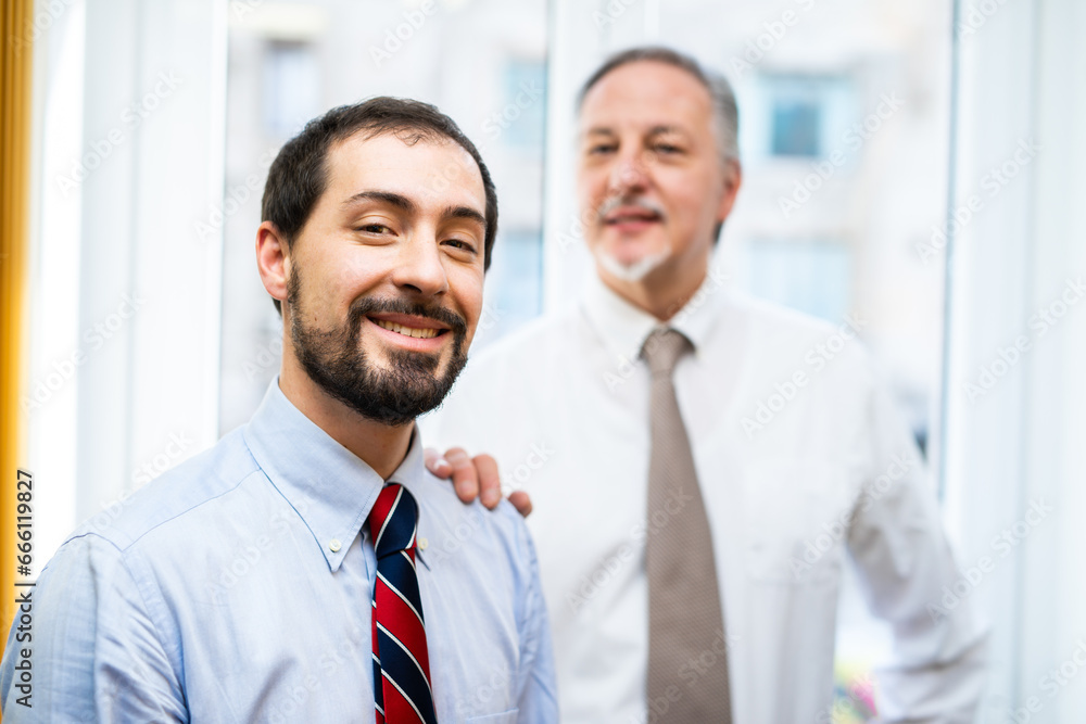 Senior manager putting his hand on a colleague's shoudler Senior manager putting his hand on a colleague's shoudler
