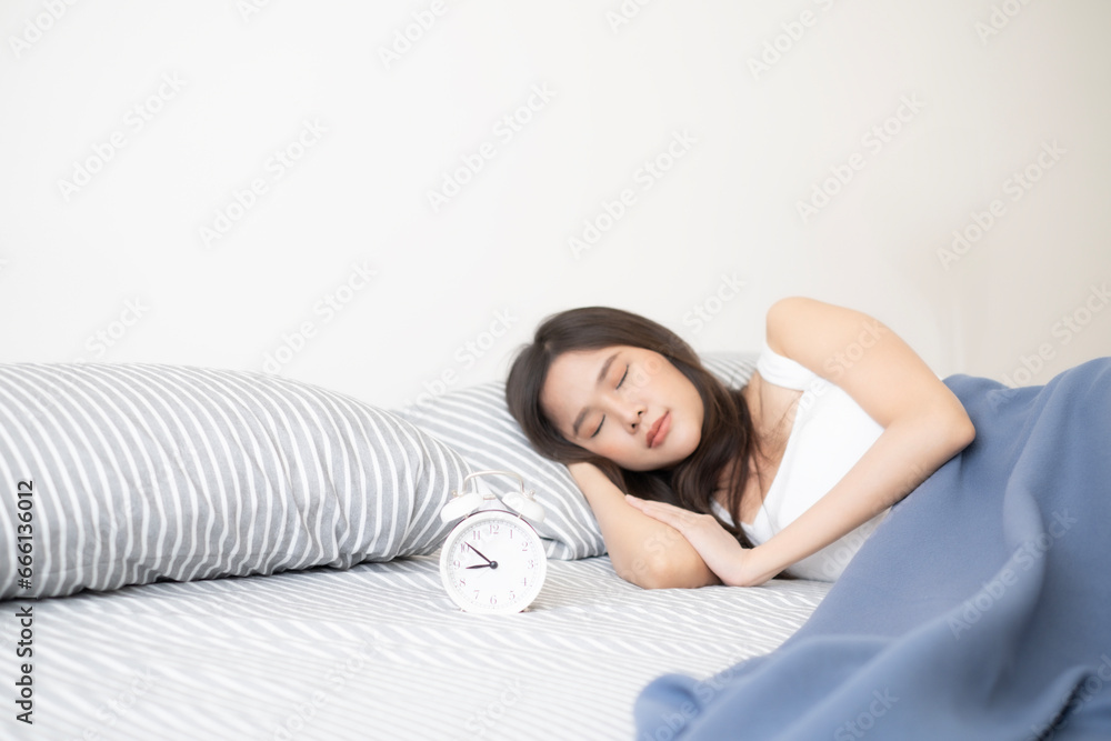 Fototapeta premium Portrait of sleepless Asian woman still sleep on bed in moning. Young Asian woman lay on bed.