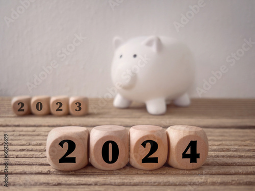 New Year financial plan concept. 2024 written on wooden blocks. With blurred styled background.