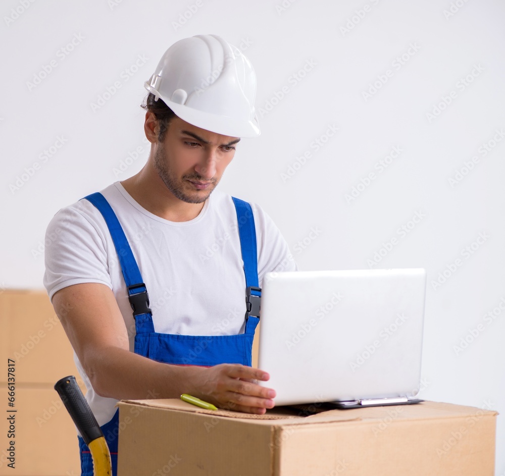 Young male professional mover doing home relocation Young male professional mover doing home relocation