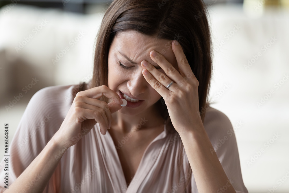 Close up face crying 30s woman takes pill feels desperate. Fatal disease, serious health problem, mental trouble need counsellor help, unwilling pregnancy abortion decision kill an unborn baby concept