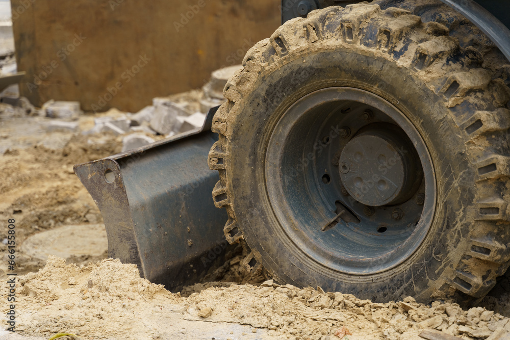 Close-up of dirty bucket teeth and excavator wheel. Close-up of dirty bucket teeth and excavator wheel.