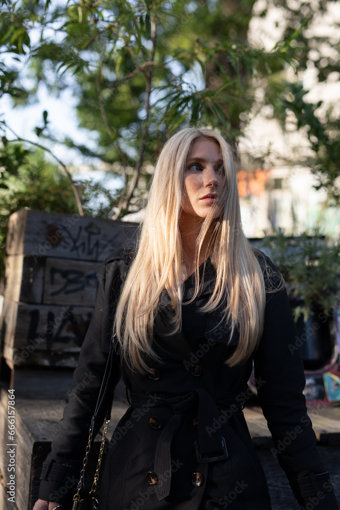 Blond wonderful woman with black dress in autum dance in the wind Blond wonderful woman with black dress in autum dance in the wind